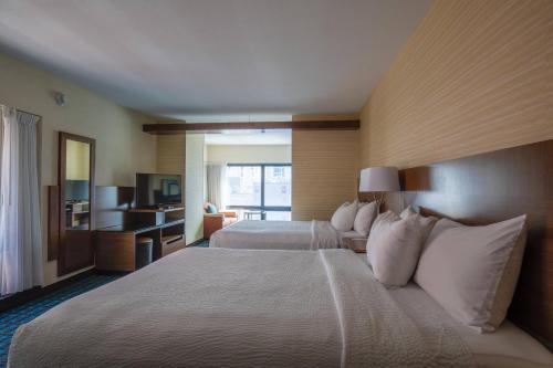 a hotel room with two beds and a television at Fairfield Inn and Suites Chicago Downtown-River North in Chicago