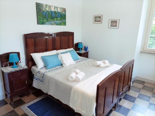 a bedroom with a large bed with towels on it at Il giardino di San Martino in Saliceto