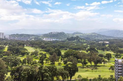 a view of a park with trees and mountains at Clark Marriott Hotel in Clark