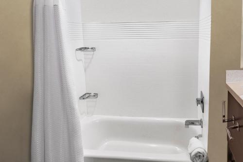 a bathroom with a white tub and a shower at TownePlace Suites by Marriott Fort Mill at Carowinds Blvd in Fort Mill