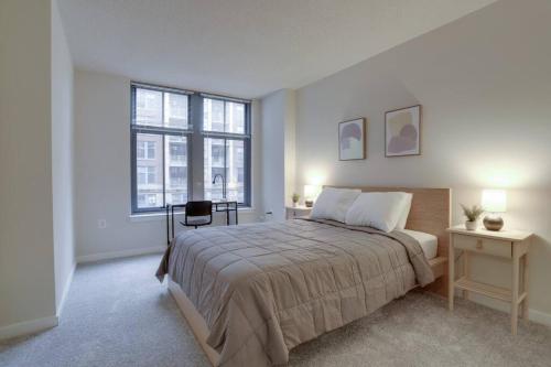 a bedroom with a bed and a desk and a window at Awesome 2 BR Apartmetn At Pentagon City with Gym in Arlington