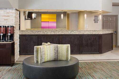 a chair in the lobby of a hotel at Residence Inn by Marriott Detroit Livonia in Livonia