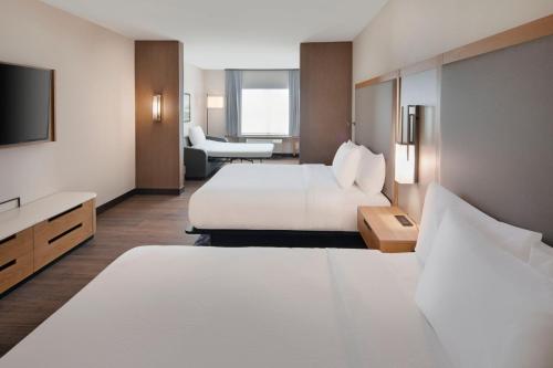 a hotel room with two beds and a television at Fairfield by Marriott Inn & Suites Franklin Cool Springs in Franklin