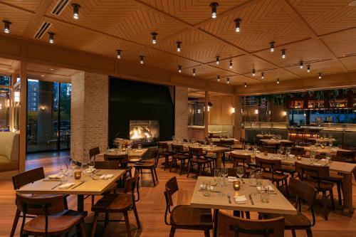 a restaurant with tables and chairs and a fireplace at W Nashville in Nashville