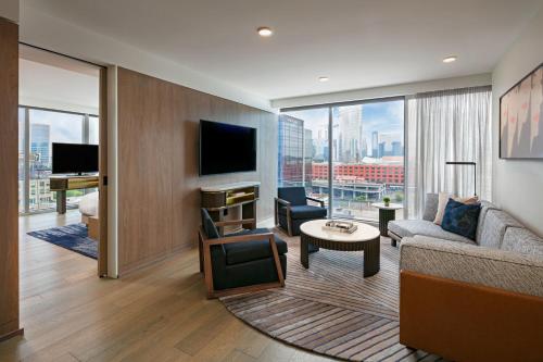 a living room with a couch and a tv at W Nashville in Nashville