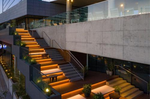a staircase in a building with tables and chairs at W Nashville in Nashville