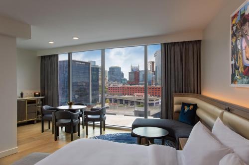 a hotel room with a bed and a large window at W Nashville in Nashville