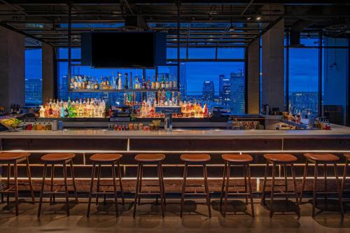 a bar with stools at a bar with a view at W Nashville in Nashville