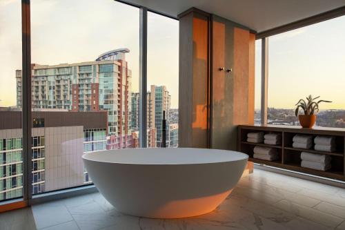 a bath tub in a bathroom with large windows at W Nashville in Nashville