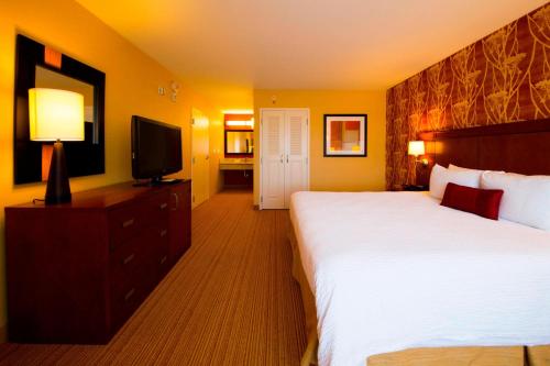 a hotel room with a bed and a television at Courtyard Warner Robins in Warner Robins