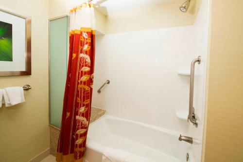 a bathroom with a tub and a shower curtain at Courtyard Warner Robins in Warner Robins