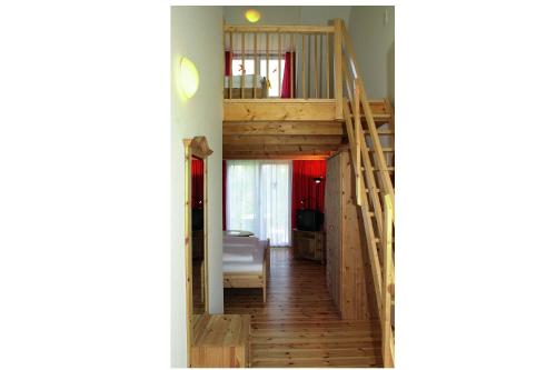 a room with a wooden staircase in a house at Hotel Sunnegässle in Rust