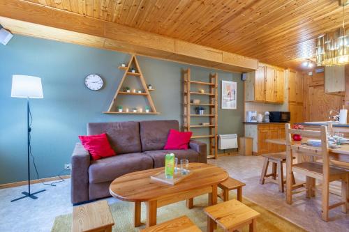 un salon avec un canapé et une table dans l'établissement Le Petit Sapin, à La Bresse