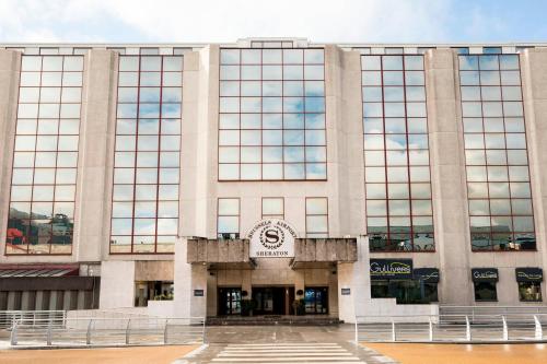 a building with a clock on the front of it at Sheraton Brussels Airport Hotel in Zaventem