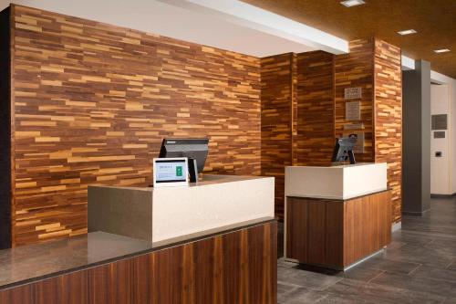 an office with a reception desk with a brick wall at Courtyard by Marriott Nashville SE/Murfreesboro in Murfreesboro