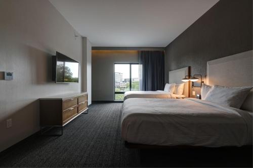 a hotel room with two beds and a window at Courtyard by Marriott Iowa City University Heights in Iowa City