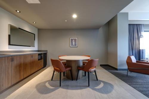 a waiting room with a table and chairs at Courtyard by Marriott Iowa City University Heights in Iowa City