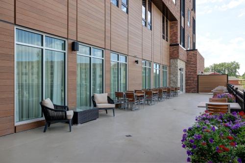 a patio with chairs and tables on a building at Courtyard by Marriott Iowa City University Heights in Iowa City
