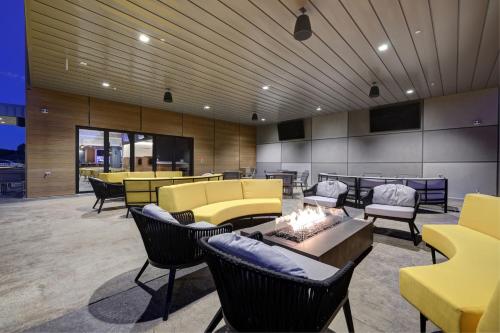 a lobby with couches and chairs and a fire place at Courtyard by Marriott Iowa City University Heights in Iowa City