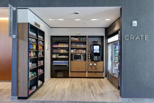 a grocery store aisle with a coffee shop at Courtyard by Marriott Iowa City University Heights in Iowa City