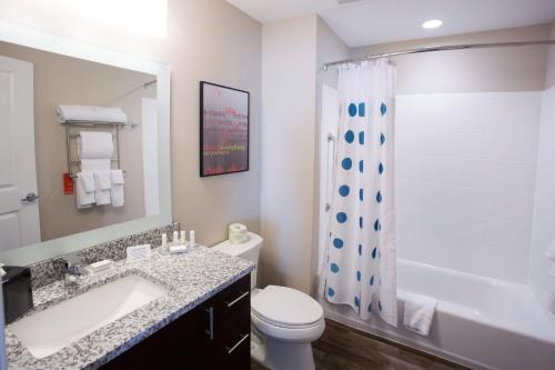 a bathroom with a sink and a toilet and a shower at TownePlace Suites by Marriott Southern Pines Aberdeen in Aberdeen