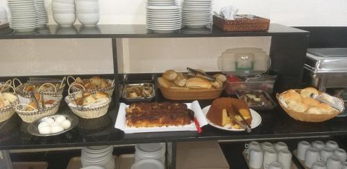 a shelf filled with different types of food at Hotel Diplomata Copacabana in Rio de Janeiro