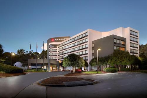 a building with a parking lot in front of it at Atlanta Marriott Peachtree Corners in Norcross