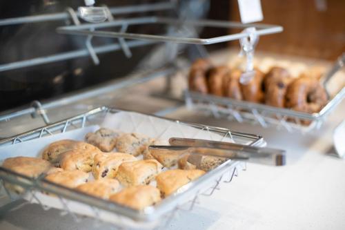a bunch of donuts are being made in a bakery at SpringHill Suites by Marriott Kenosha in Kenosha