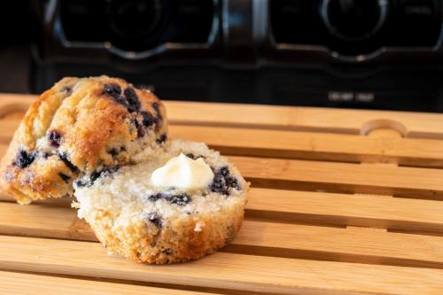 a blueberry muffin sitting on a cutting board at SpringHill Suites by Marriott Kenosha in Kenosha