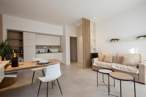 a living room with a couch and a table and chairs at Giada Luxury in Terrasini