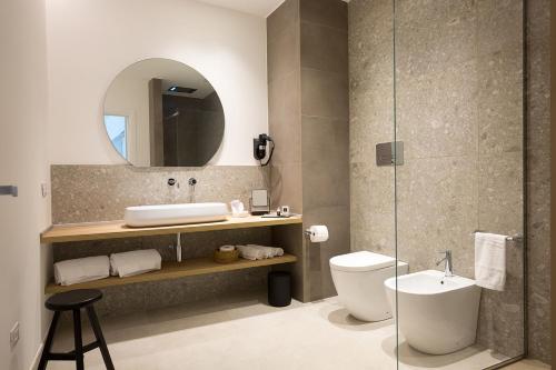 a bathroom with a sink and a toilet and a mirror at Giada Luxury in Terrasini