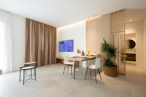 a dining room with a table and chairs in a room at Giada Luxury in Terrasini