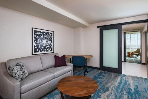 a living room with a couch and a table at The Westin Dallas Southlake in Southlake
