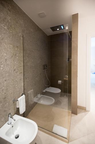 a bathroom with a sink and a shower and a toilet at Giada Luxury in Terrasini