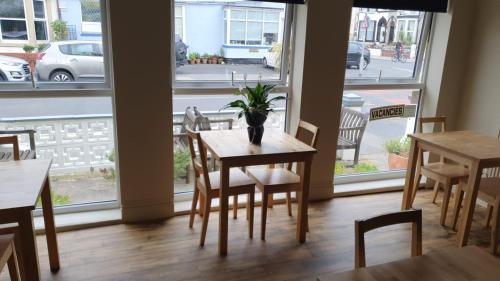 a dining room with a table and chairs and a window at The Lenbrook in Blackpool