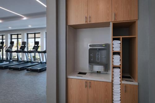 a gym with a television and rows of exercise machines at Courtyard by Marriott Colorado Springs North, Air Force Academy in Colorado Springs