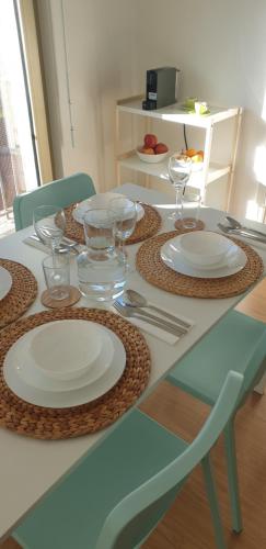 a table with plates and wine glasses on it at Free parking & 5min walk to Subway in Lisbon