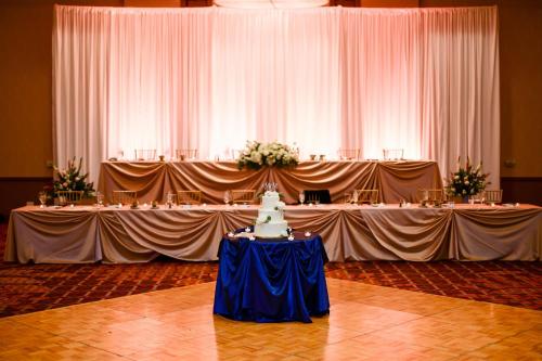 a table with a wedding cake on top of it at Chicago Marriott Naperville in Naperville