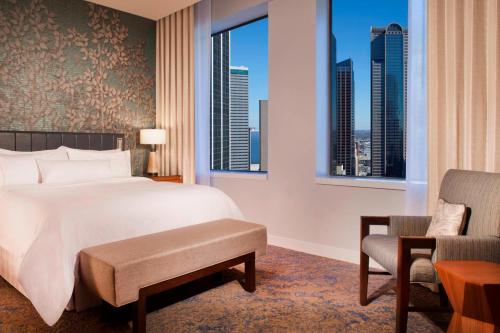 a bedroom with a bed and a view of the city at The Westin Dallas Downtown in Dallas