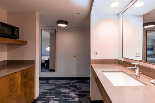 a bathroom with a sink and a mirror at Fairfield Inn by Marriott Evansville West in Evansville