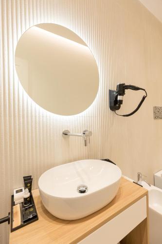 a bathroom with a white sink and a mirror at Giada Luxury in Terrasini