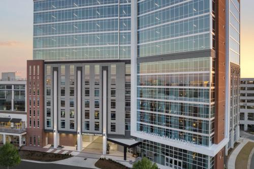 an aerial view of a tall office building at AC Hotel by Marriott Charlotte Ballantyne in Charlotte