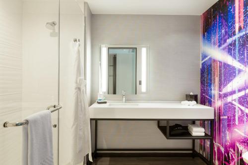 a bathroom with a sink and a mirror at Aloft San Juan in San Juan