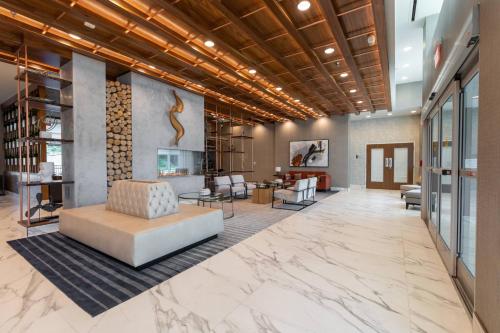 an office lobby with a couch and chairs at Delta Hotels by Marriott Raleigh-Durham at Research Triangle Park in Durham