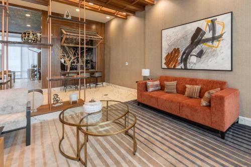 a living room with a couch and a glass table at Delta Hotels by Marriott Raleigh-Durham at Research Triangle Park in Durham
