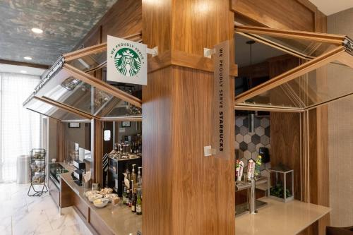 a bar in a room with wooden walls at Delta Hotels by Marriott Raleigh-Durham at Research Triangle Park in Durham