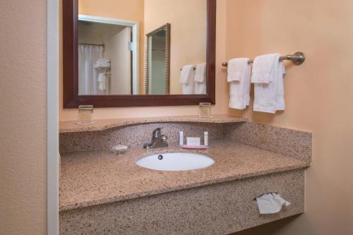 a bathroom with a sink and a mirror at SpringHill Suites Prince Frederick in Prince Frederick