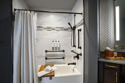 a bathroom with a sink and a shower at The Barfield, Autograph Collection in Amarillo