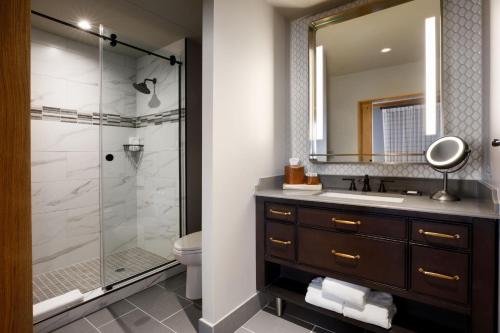 a bathroom with a sink and a shower at The Barfield, Autograph Collection in Amarillo