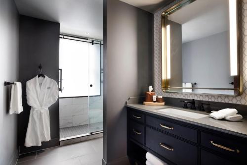 a bathroom with a sink and a shower at The Barfield, Autograph Collection in Amarillo